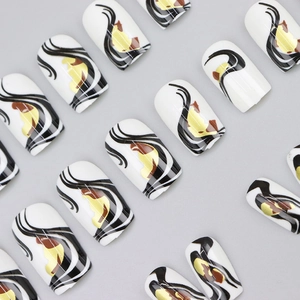 Abstract white press-on nails with black stripes and gold accents in squoval shape