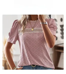 Detailed shot of pink short sleeve top with eyelet embroidery and lace patchwork