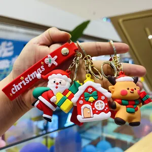 Detailed close-up of Santa, reindeer and snow house PVC Christmas keychains