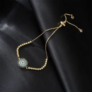 Detail of adjustable evil eye bracelet with turquoise zircon fan charm on black leather