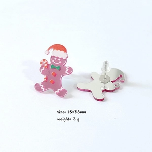 Pink gingerbread man earrings with dimensions 18x26mm shown on white background