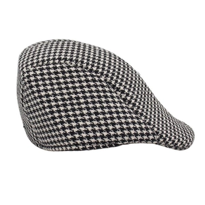 Macro detail of classic black and white houndstooth fabric on a flat ivy cap