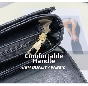Detail of minimalist black crossbody bag with golden zipper and high-quality leather texture