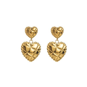 Macro detail of golden double-heart earrings with textured quilted metal finish