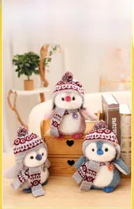 Detailed plush penguin dolls in blue pink and grey with knit hats and matching scarves
