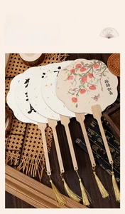 Detailed view of traditional Chinese silk fans with wooden handles and golden tassels
