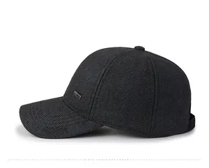 Detail of grey wool baseball cap showing sport embroidery and side metal plaque decoration