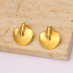 Minimalist golden petal stud earrings on textured stone surface with high gloss finish