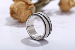 Macro detail of brushed silver stainless steel ring with dual black enamel parallel lines