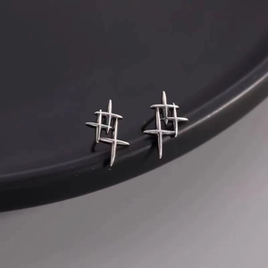Detailed macro view of 925 sterling silver thorn earrings with sharp geometric design