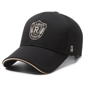 Black baseball cap with shield embroidery and beige brim trim on white background