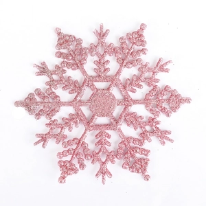 Gros plan d'un flocon de neige rose pailleté pour décorer le sapin et les couronnes