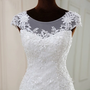 Close-up of intricate lace wedding dress with 3D floral embroidery and sequins
