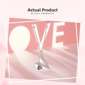 Detailed macro view of S925 silver paper plane pendant with colorful heart zircon stone