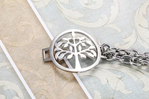 Detailed close-up of a stainless steel tree of life pendant with S925 engraved clasp