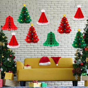 Christmas honeycomb paper ornaments featuring trees, bells and hats on a festive background