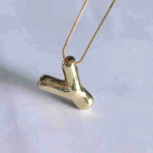 Detailed view of gold puff balloon letter Y pendant with a sleek box chain necklace