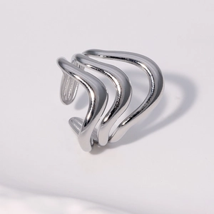 Macro detail of silver layered wave ring with mirror finish and liquid metal aesthetic
