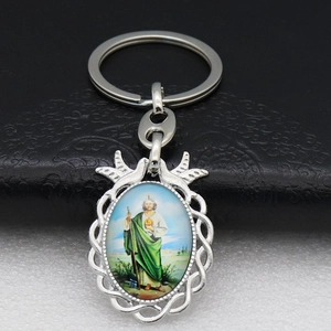 Detail of silver metal keychain with St. Jude Thaddeus religious icon and ornate border