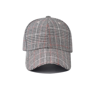 Close-up detail of the grey and red plaid embroidery on the classic baseball cap