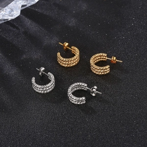 Detailed top view of triple-layered gold and silver stainless steel hoop earrings