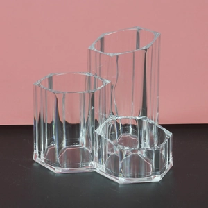Macro view of clear acrylic hexagon lipstick organizer with three tiered compartments