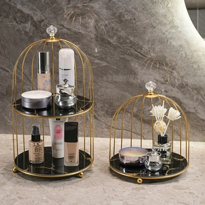 Golden birdcage makeup organizer with marble tiers for luxury bathroom vanity storage
