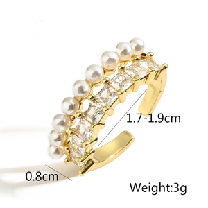 Detail shot of gold-plated ring with layered pearls and square zirconias showing 0.8cm width