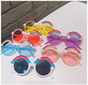 Detail showing six colorful round children's sunglasses with rainbow and cloud decorations