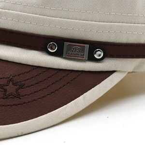 Detail of army cap featuring cream canvas with leather brim and five-pointed star stitching