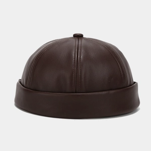 Detailed close-up showing the premium texture of the dark brown PU leather docker cap