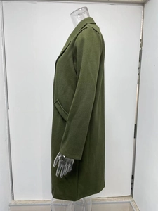 Detail view of green mid-length wool coat with notch lapels and side pockets