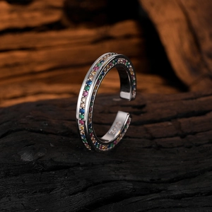 Minimalist S925 silver open ring with colorful rainbow zircon stones on dark wood