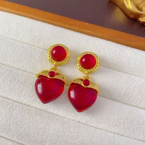 Vintage red heart pendant earrings with gold metal frame and floral tassel accent