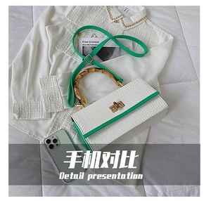 Size comparison of a white croc-embossed bag with bamboo handle and green strap