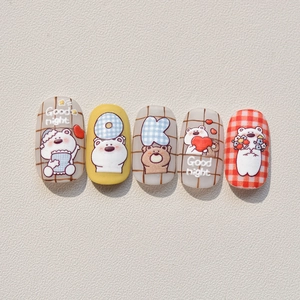 Detail showing 5-piece set of cartoon bear and checkered embossed nail art stickers