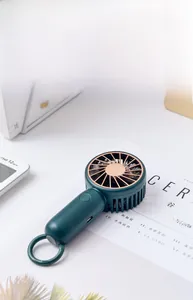 Close-up of portable green USB fan with rose gold mesh and integrated carabiner hook