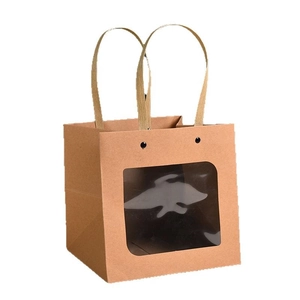 Brown kraft paper gift bag with rectangular clear window and woven handles on white background