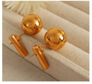 Macro shot of 18k gold plated stainless steel stud earrings with geometric drop design