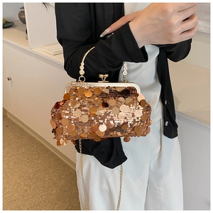 Close-up of luxury gold sequin clutch bag with vintage metal handle and detachable chain