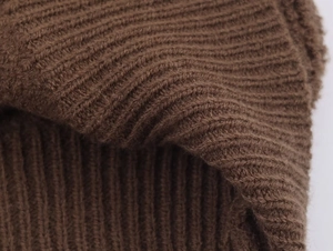 Macro detail of coffee brown ribbed knit fabric showing soft texture of pilot jacket