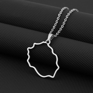 Macro detail of silver stainless steel Reunion Island map pendant with a fine cable chain