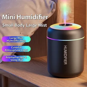 Black desktop humidifier with colorful LED light on a wooden bedside table in bedroom
