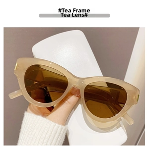Close-up of cat-eye sunglasses featuring tea frames and matching dark tea lenses