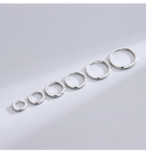 Macro shot of minimalist S925 sterling silver hoop earrings in six different sizes