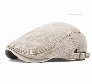 Detailed view of khaki cotton beret hat with adjustable bronze metal buckle and stitching