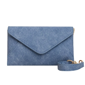 Blue denim envelope shoulder bag with V-shaped flap and gold chain strap detail