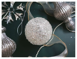 Close-up of silver Christmas ornaments with white sequins ball and glitter snowflakes