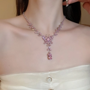 Close-up of pink zircon butterfly necklace with waterdrop pendant on model's neck