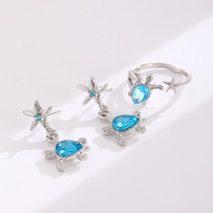 Ocean theme jewelry set with silver turtle ring and starfish earrings with blue gems